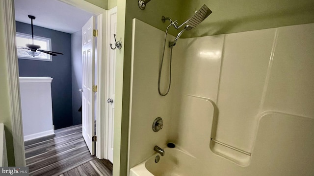 bathroom with shower / tub combination and hardwood / wood-style floors