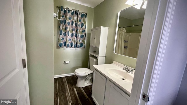 bathroom with vanity, hardwood / wood-style flooring, toilet, and walk in shower