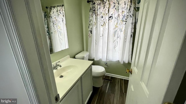 bathroom featuring hardwood / wood-style flooring, vanity, and toilet