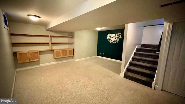 basement featuring light carpet