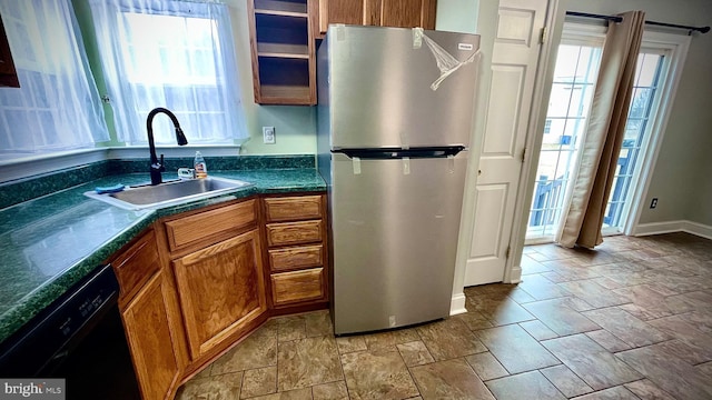 kitchen with stainless steel fridge, dishwasher, and sink