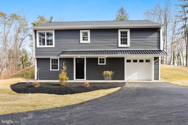 view of front of property with a garage and a front lawn