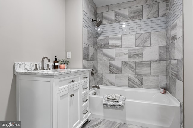 bathroom featuring vanity and tiled shower / bath combo