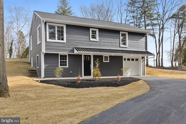 view of front facade featuring a garage and a front yard