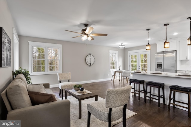 living room featuring dark wood-type flooring, ceiling fan, and french doors