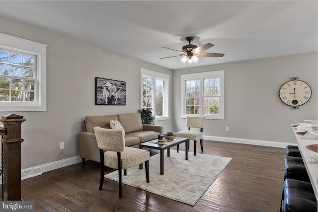 living room with ceiling fan, dark hardwood / wood-style floors, and a wealth of natural light