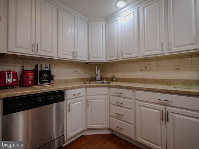 kitchen featuring tasteful backsplash, white cabinets, sink, and dishwasher