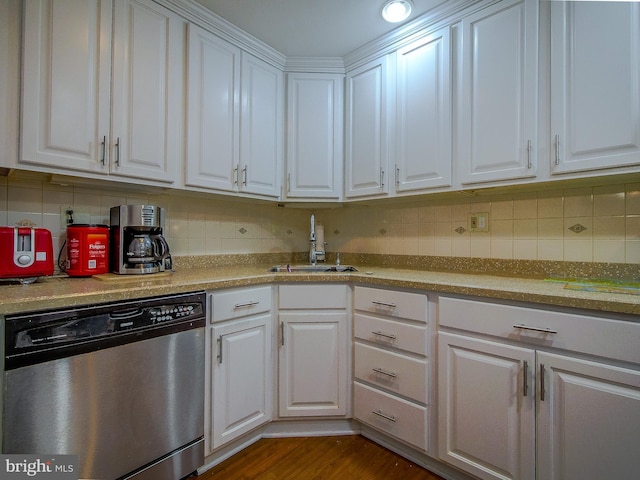 kitchen with sink, dark hardwood / wood-style floors, tasteful backsplash, white cabinets, and stainless steel dishwasher