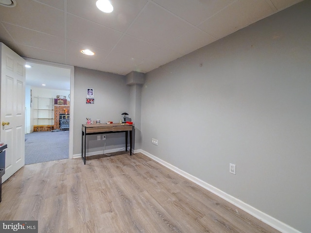 interior space with light hardwood / wood-style floors and a drop ceiling