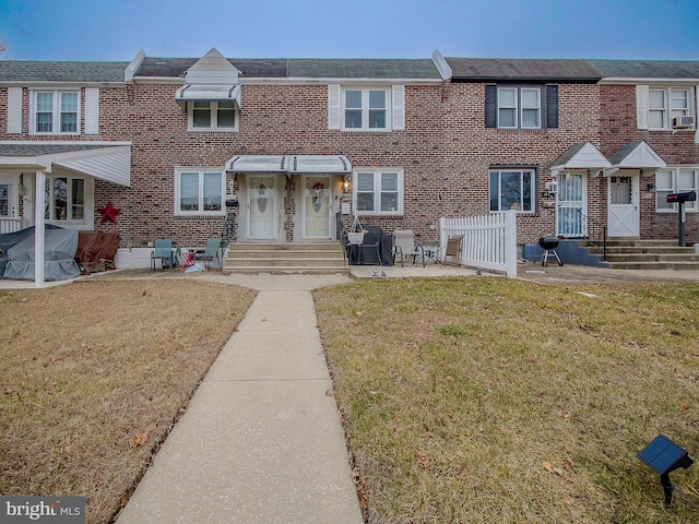 view of property featuring a front yard