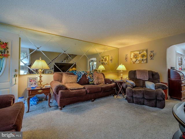 carpeted living room featuring a textured ceiling