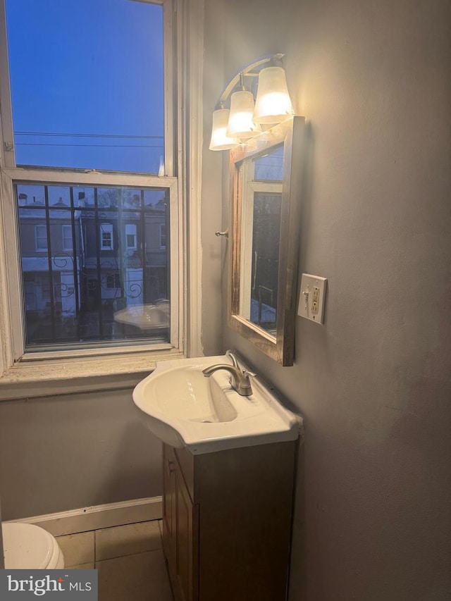 bathroom with vanity, tile patterned floors, and toilet