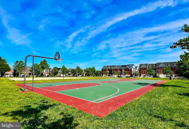 view of sport court featuring a yard