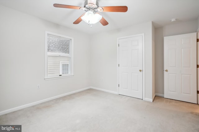 unfurnished bedroom featuring light carpet and ceiling fan