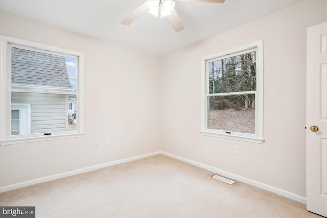 carpeted empty room featuring ceiling fan