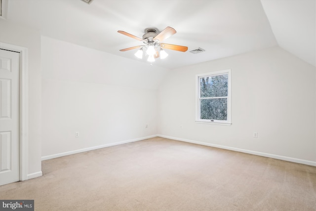 bonus room with lofted ceiling, light carpet, and ceiling fan