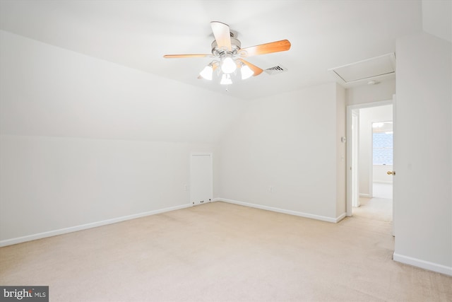 additional living space with vaulted ceiling, light colored carpet, and ceiling fan