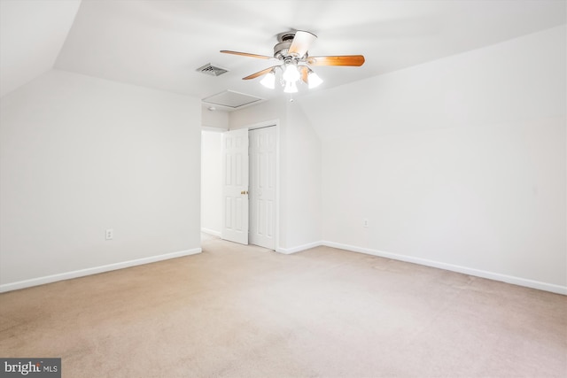 interior space with ceiling fan, light colored carpet, lofted ceiling, and a closet