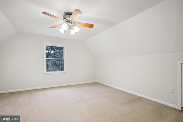 additional living space with lofted ceiling, light colored carpet, and ceiling fan