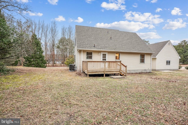 back of house with cooling unit, a yard, and a deck