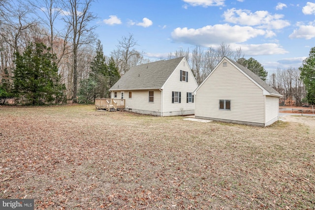 back of house with a wooden deck and a yard