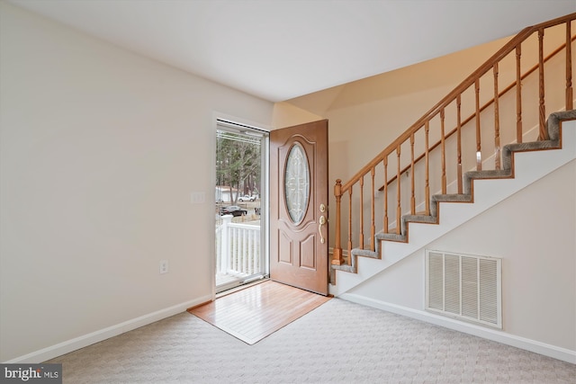 entrance foyer with light colored carpet