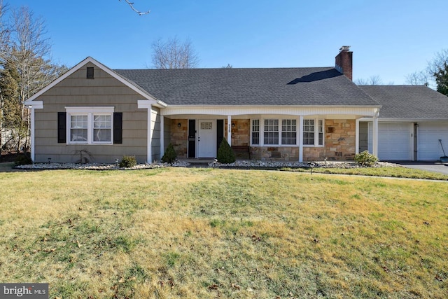 ranch-style home featuring a garage, a front yard, and a porch