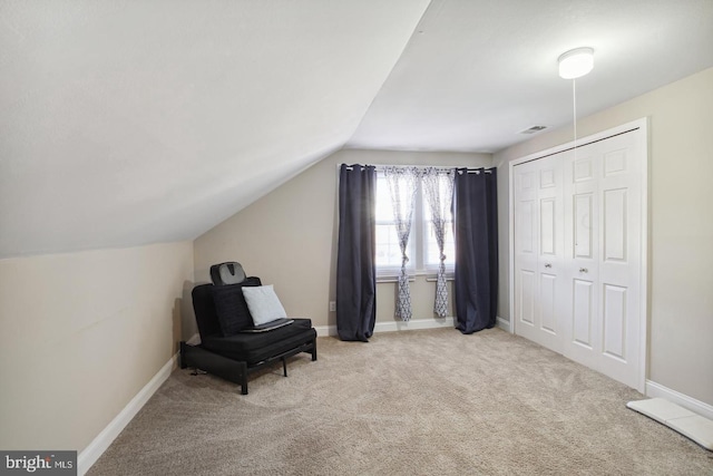 sitting room featuring light colored carpet and lofted ceiling