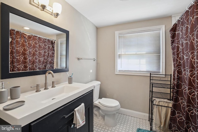 bathroom featuring vanity, tile patterned floors, and toilet