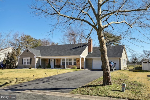 ranch-style home with a garage and a front yard