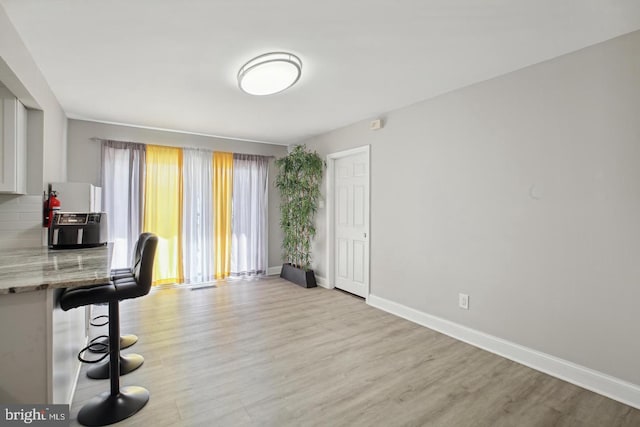 unfurnished dining area with light wood-type flooring