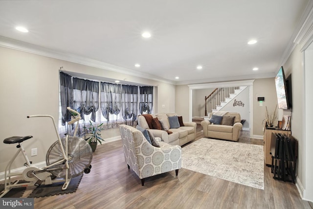 living room featuring ornamental molding, hardwood / wood-style floors, and a wealth of natural light