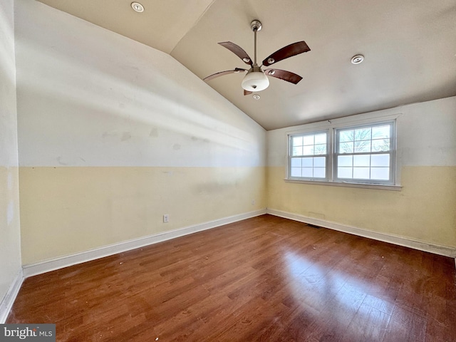 unfurnished room featuring vaulted ceiling, dark hardwood / wood-style floors, and ceiling fan