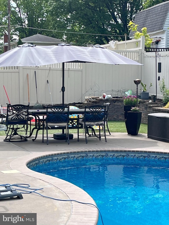 view of swimming pool featuring a patio area and central air condition unit