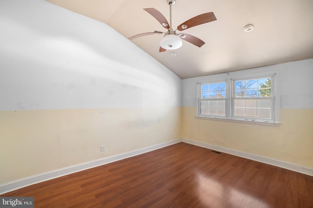 spare room featuring hardwood / wood-style flooring, lofted ceiling, and ceiling fan