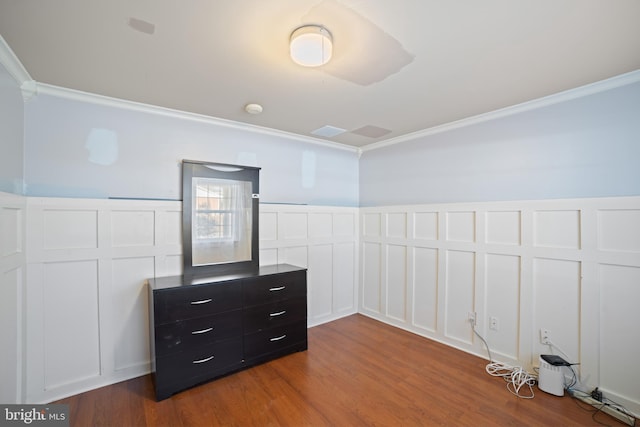 spare room with ornamental molding and hardwood / wood-style floors