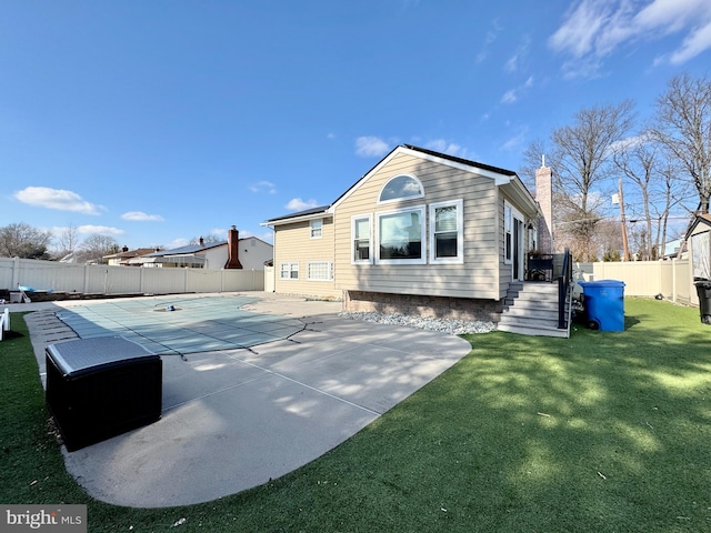 back of house featuring a yard and a patio