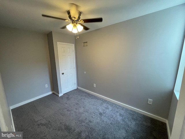 carpeted spare room with ceiling fan