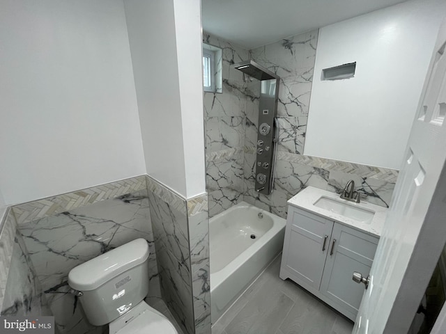 full bathroom with vanity, tiled shower / bath combo, tile walls, and toilet