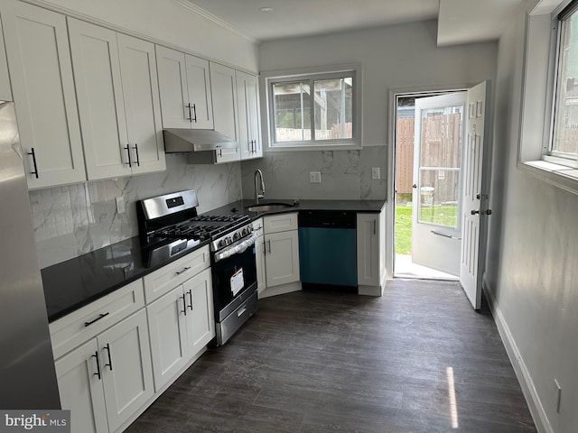 kitchen featuring appliances with stainless steel finishes, a wealth of natural light, white cabinetry, sink, and decorative backsplash