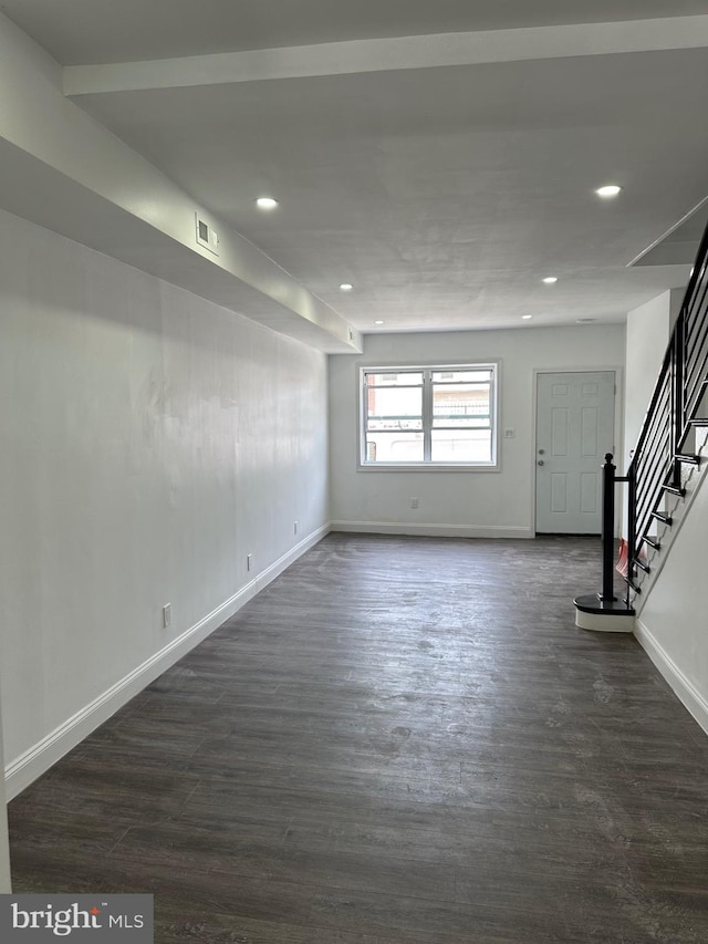 unfurnished room featuring dark wood-type flooring