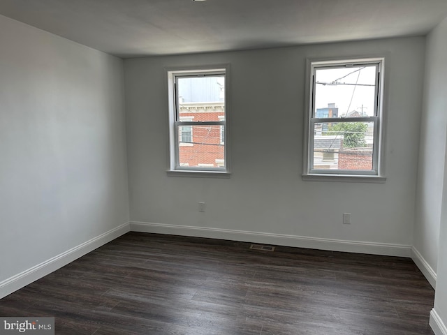 spare room featuring dark hardwood / wood-style floors