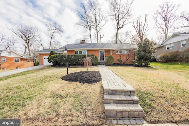 single story home with a garage, brick siding, a chimney, and a front yard