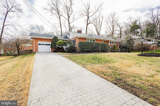 ranch-style house featuring a garage and a front lawn