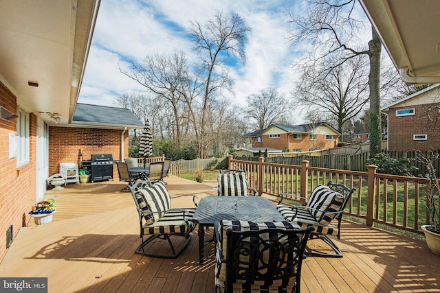 wooden deck featuring a grill