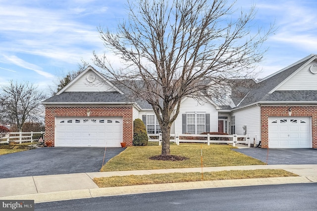 single story home with a garage and a front yard