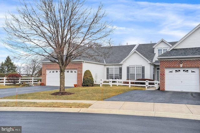 view of front of home with a garage and a front lawn