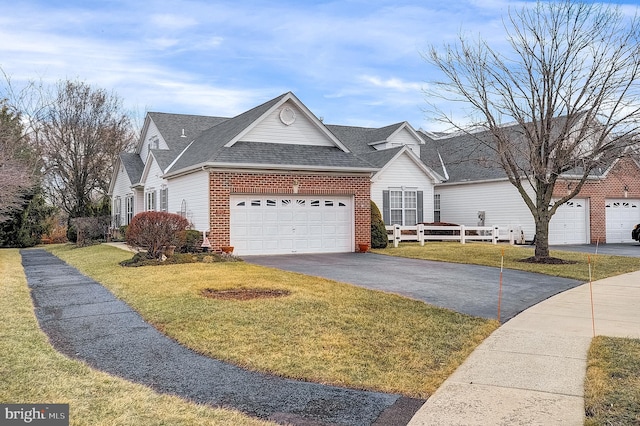 ranch-style home with a garage and a front lawn