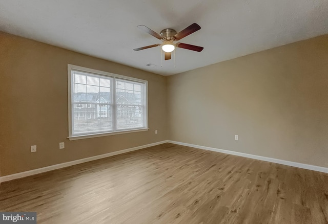 spare room with light hardwood / wood-style flooring and ceiling fan