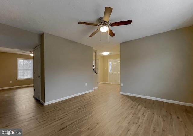 unfurnished room with hardwood / wood-style flooring, a textured ceiling, and ceiling fan